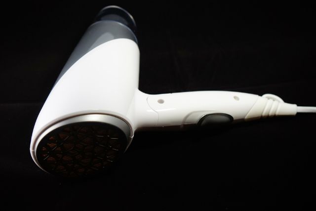 White hairdryer with a black background